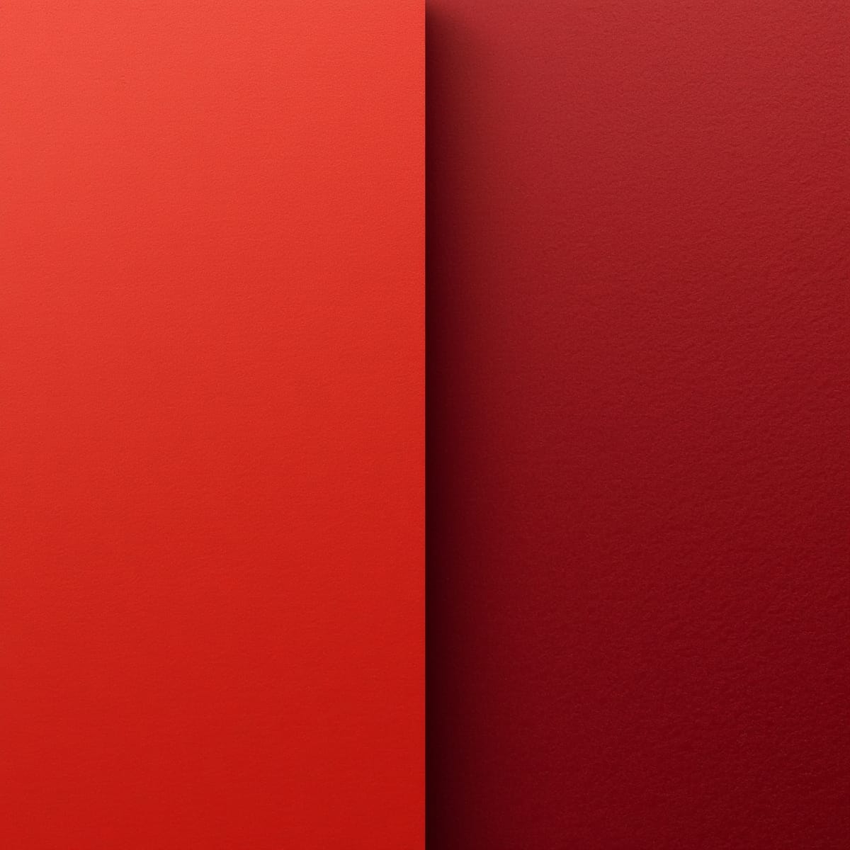 Warm tomato red swatch beside a cool burgundy swatch